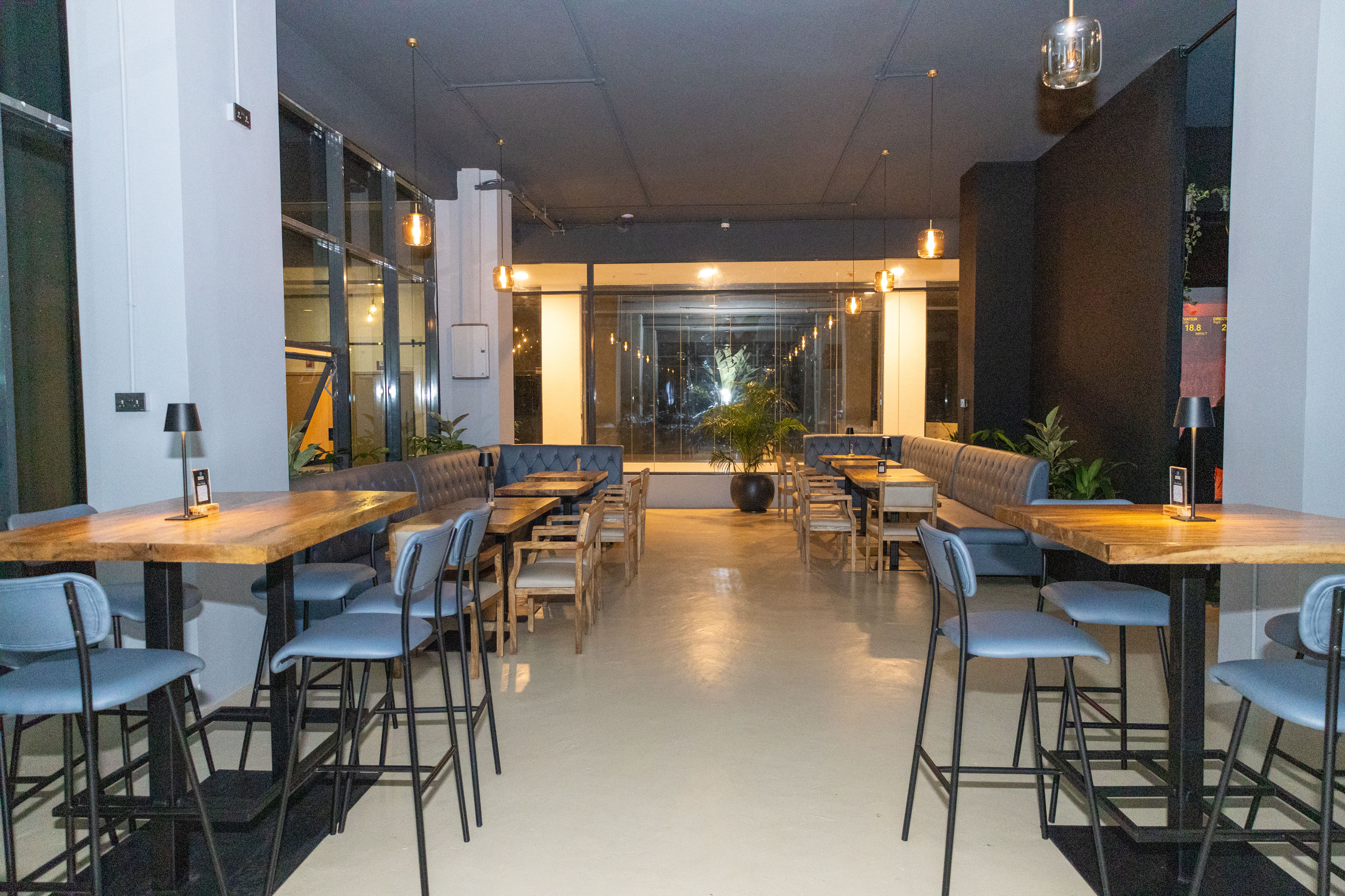 Interior of a modern, empty restaurant with blue chairs